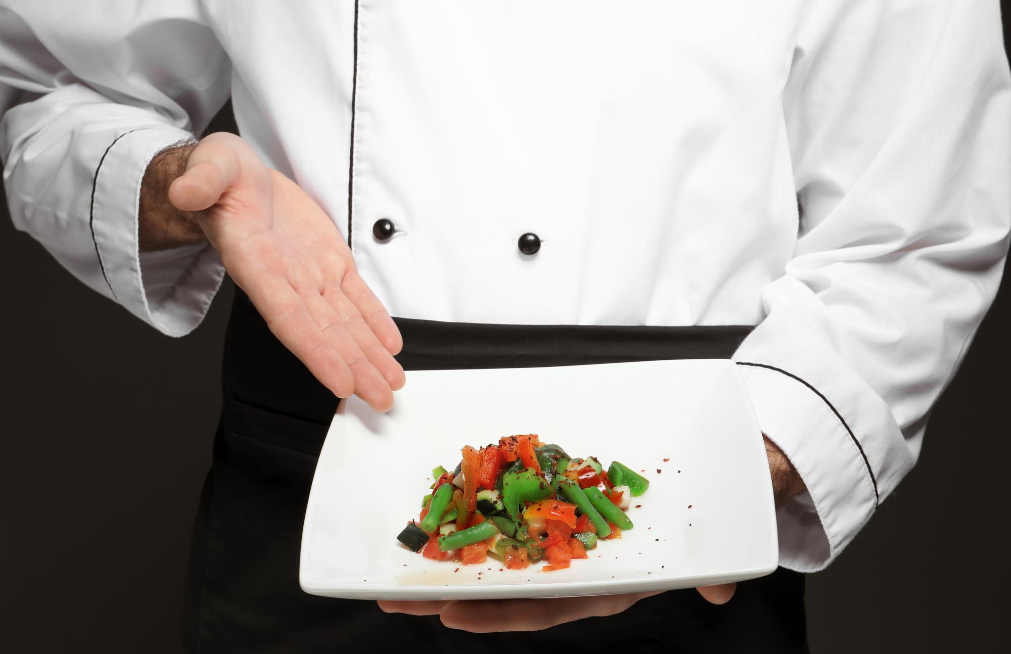 Chef arranging plate in modern kitchen